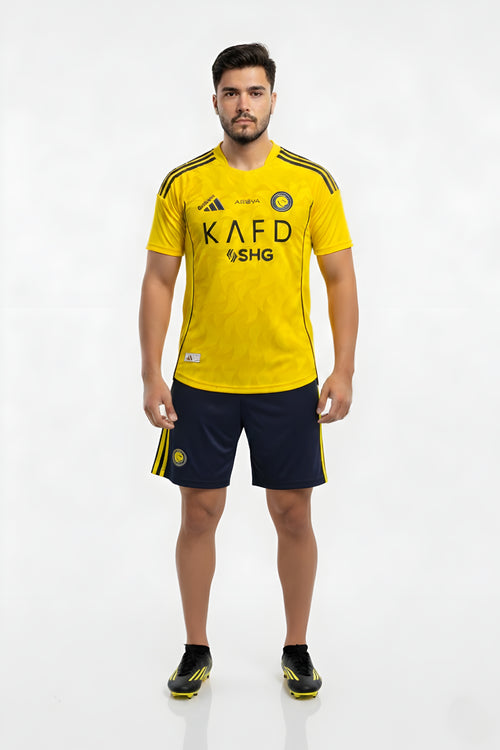 Person wearing a yellow sports jersey with black shorts on a white background